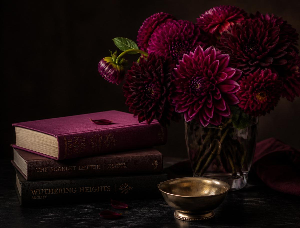 Dahlias with a stack of books on self mastery and intentional living